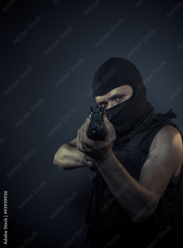 terrorist carrying a machine gun and balaclava