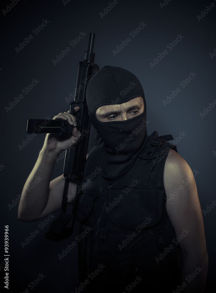 Thug, terrorist carrying a machine gun and balaclava