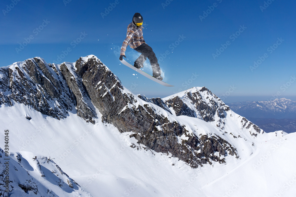 Flying snowboarder on mountains Flying snowboarder on mountains