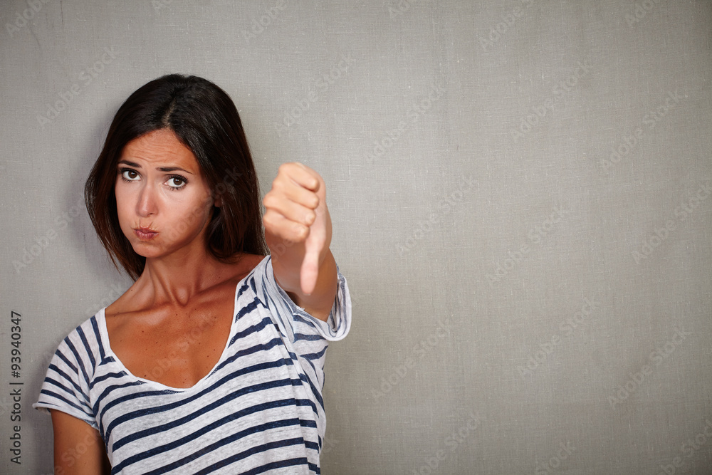 Unsatisfied young lady showing disapproval sign Unsatisfied young lady showing disapproval sign