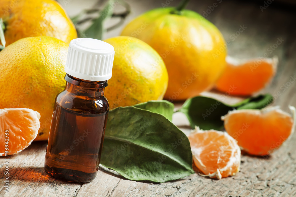 Aromatic tangerine oil, with tangerines on a wooden background, Aromatic tangerine oil, with tangerines on a wooden background,