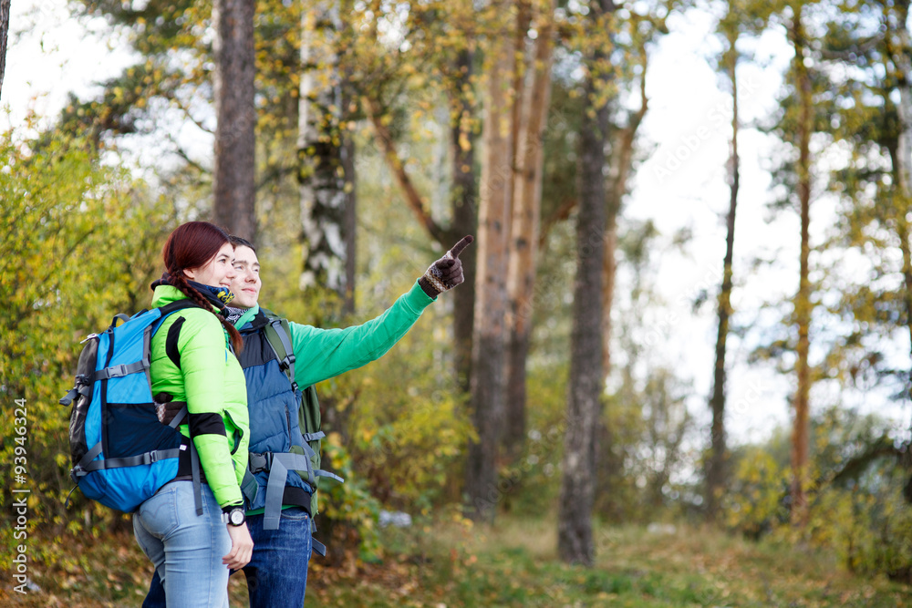 people hiking, man and woman looking around