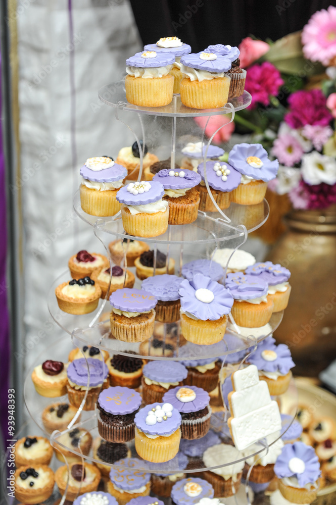 Wedding decoration with pastel colored cupcakes, meringues, muffins and macarons. Elegant and luxurious event arrangement with colorful macaroons. 