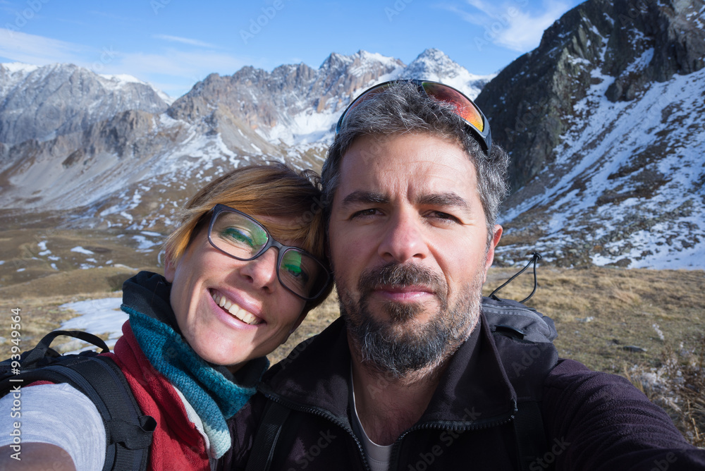 Couple of hikers taking selfie in the Alps