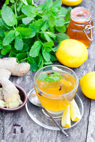 Herbal tea with lemon and ginger on wooden table