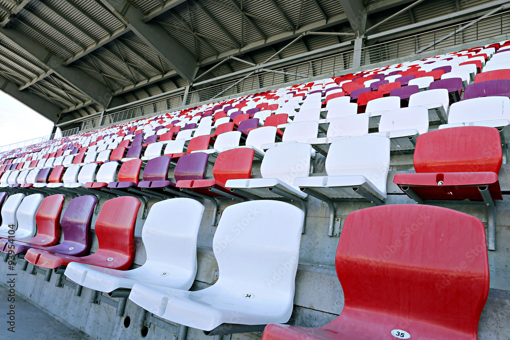 Fototapeta premium Multicolored chairs on the stadium