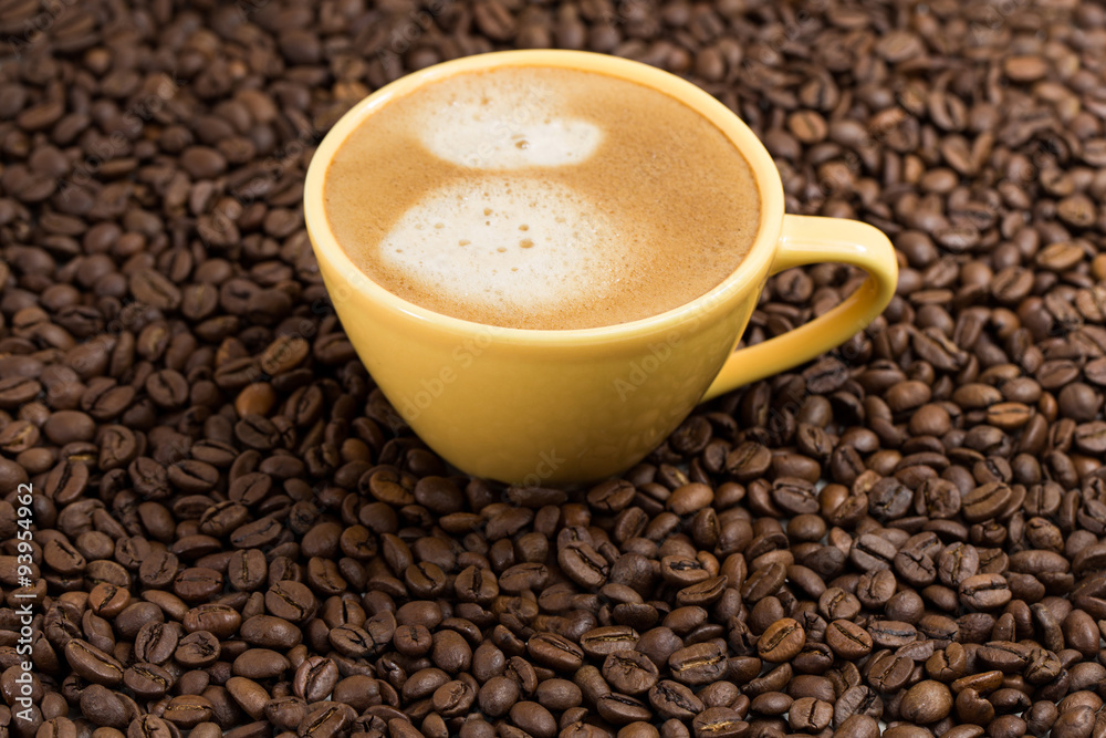 Yellow coffee Cup and roasted coffee beans around Yellow coffee Cup and roasted coffee beans around