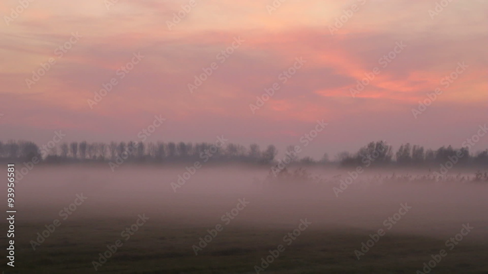 Sunset in a foggy winter landscape Sunset in a foggy winter landscape