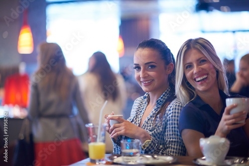 girls have cup of coffee in restaurant