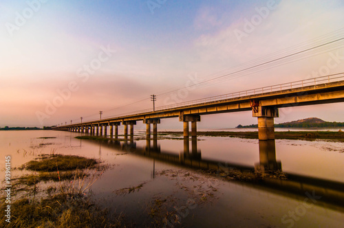 railroad bridge on sunset background. © petcharapj