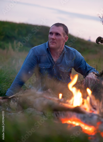 Man near bonfire in nature