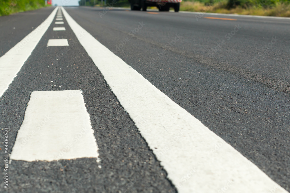 Asphalt road with white double solid line