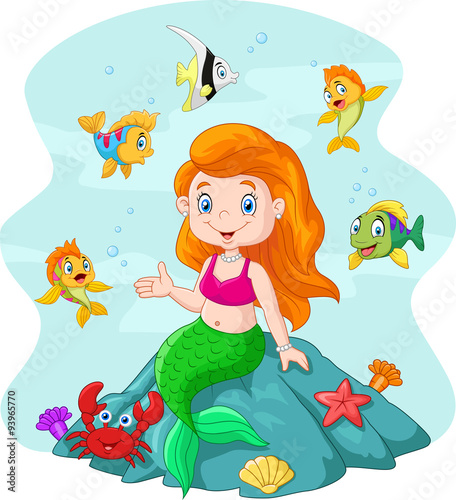Happy little mermaid sitting on the rock surrounded by fishes