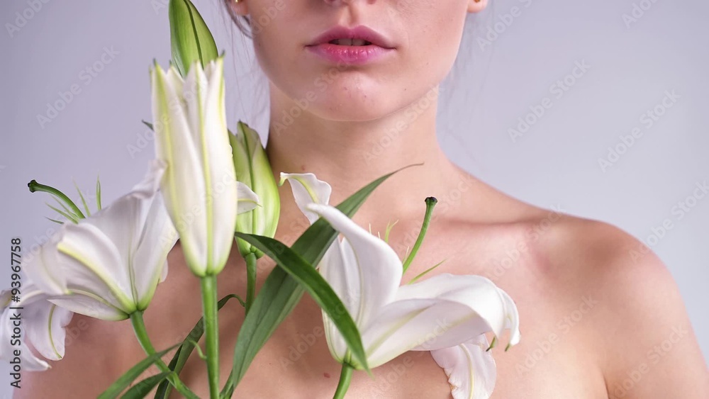 Close-up face of a girl with a flower. Slight turn of the head. Close-up face of a girl with a flower. Slight turn of the head.