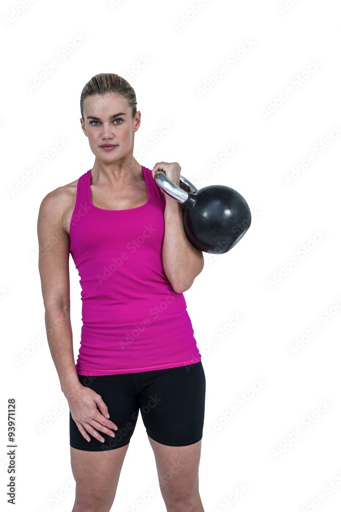 Muscular woman exercising with kettlebell Muscular woman exercising with kettlebell