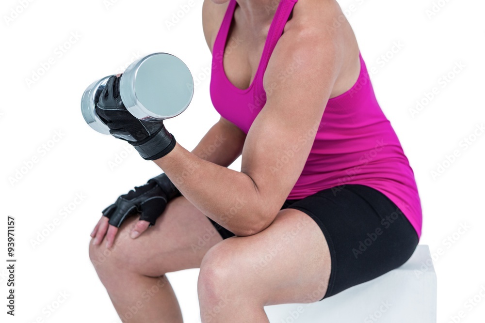 Muscular woman exercising with dumbbells Muscular woman exercising with dumbbells