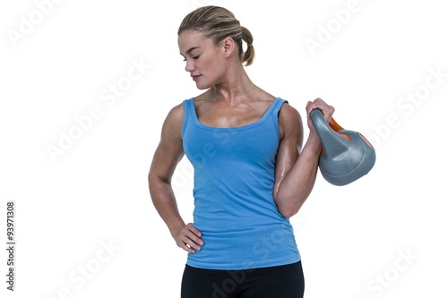 Muscular woman exercising with dumbbells  © WavebreakMediaMicro