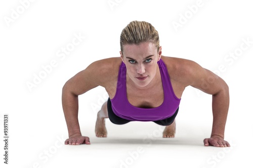 Muscular woman doing push ups 