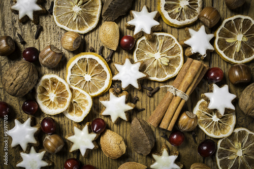 christmas background with ginger-breads, fruits, herbs and spices