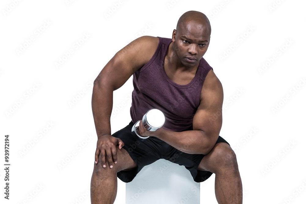 Fit man exercising with dumbbells
