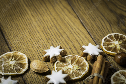 christmas background with ginger-breads, fruits, herbs and spices