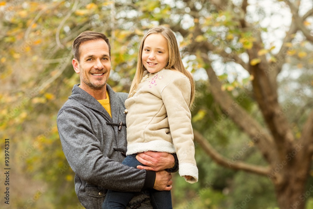 Happy father and his daughter posing in park