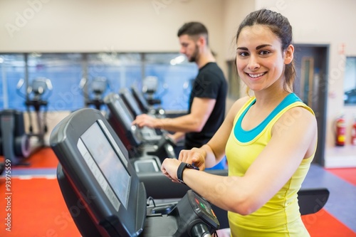 Couple using treadmills together