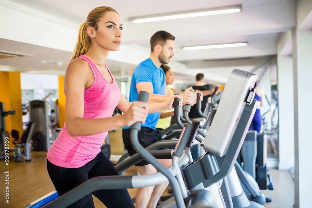 Fit people working out using machines Fit people working out using machines