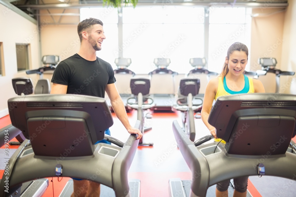 Man and woman using treadmills