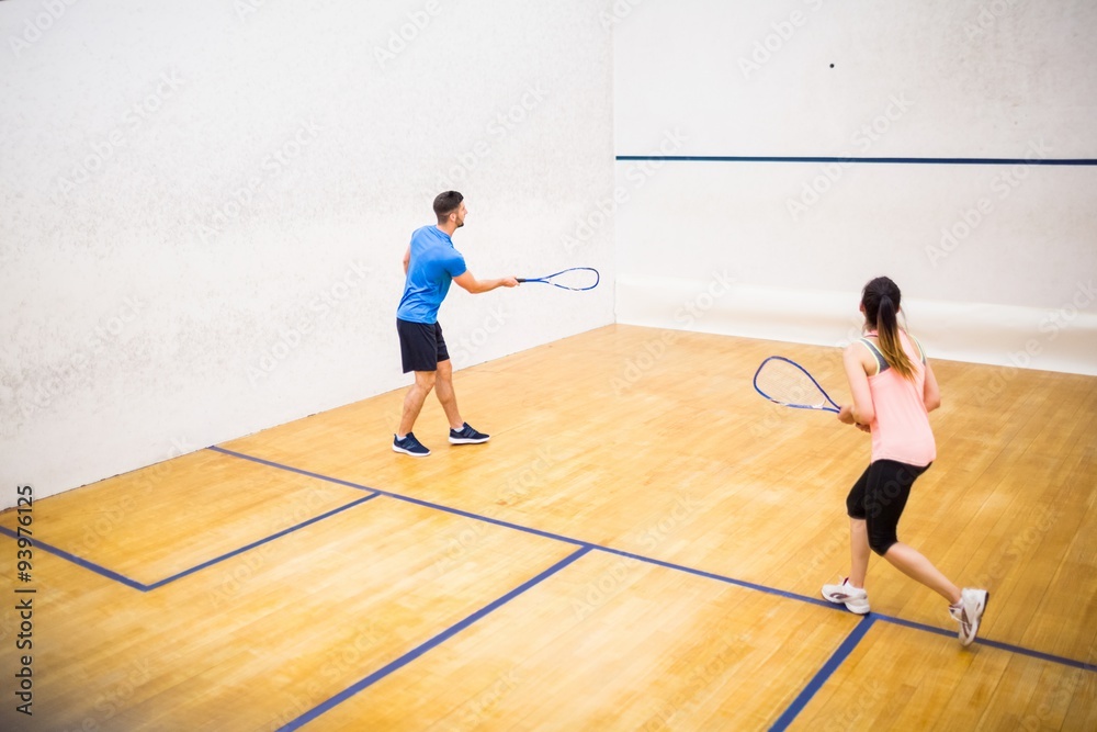 Couple playing a game of squash