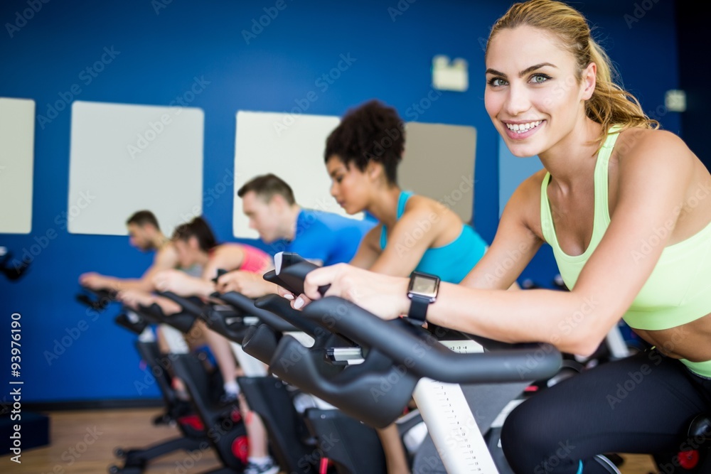 Fit people in a spin class Fit people in a spin class