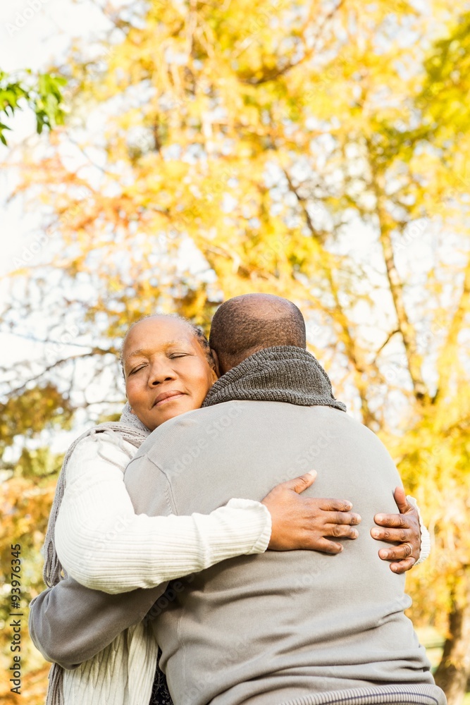 Peaceful happy senior couple embracing
