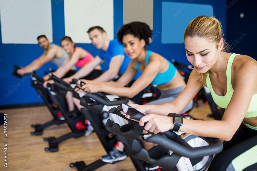 Fit people in a spin class Fit people in a spin class