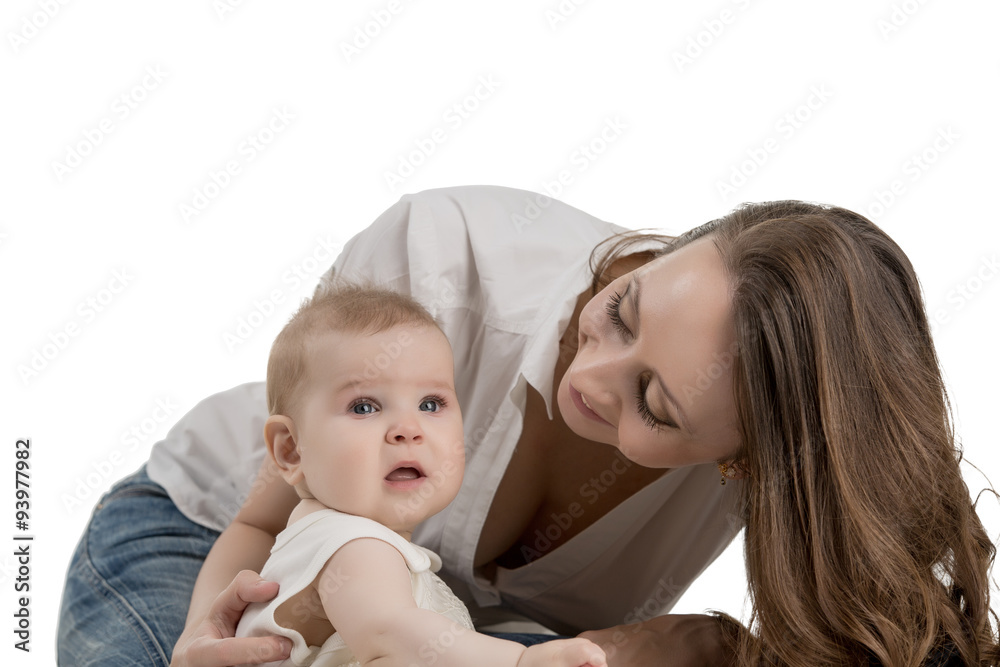 Smiling mother looking at her adorable daughter Smiling mother looking at her adorable daughter