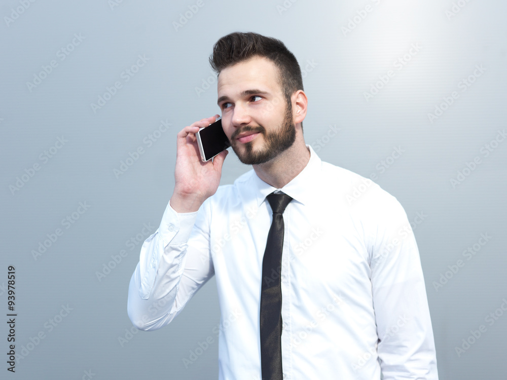 Businessman using cellphone, handsome businessman on creative ba Businessman using cellphone, handsome businessman on creative ba
