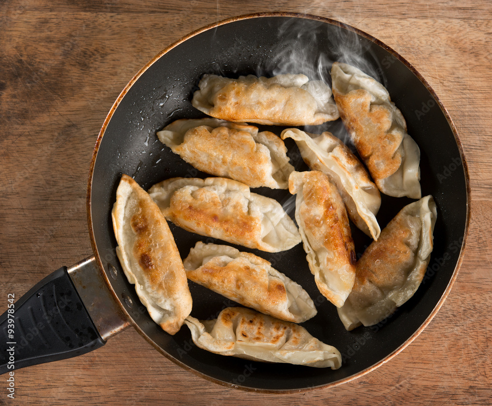 Asian dish fried dumpling in cooking pan Asian dish fried dumpling in cooking pan