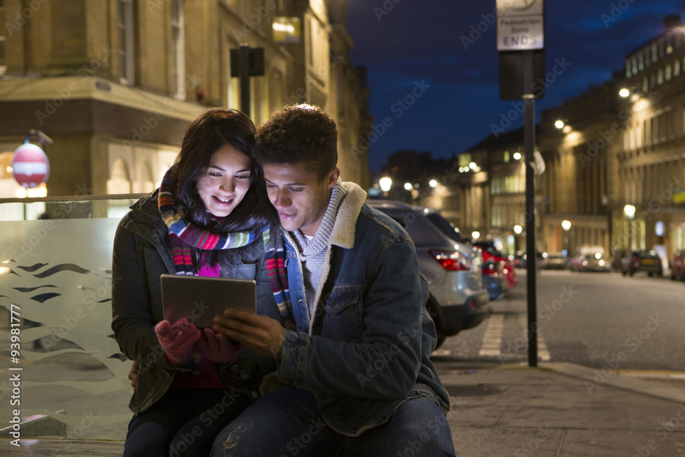Couple looking at digital tablet in the city