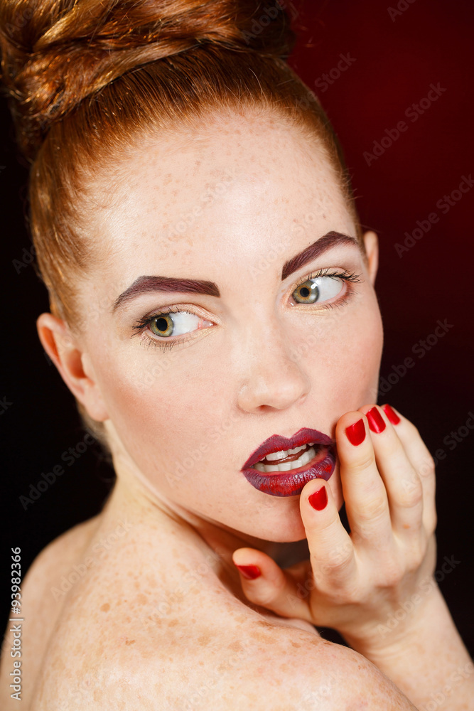 Studio portrait of a redhead female model. Studio portrait of a redhead female model.