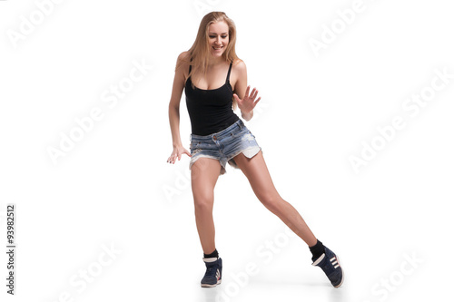 Young beautiful dancer posing on studio background