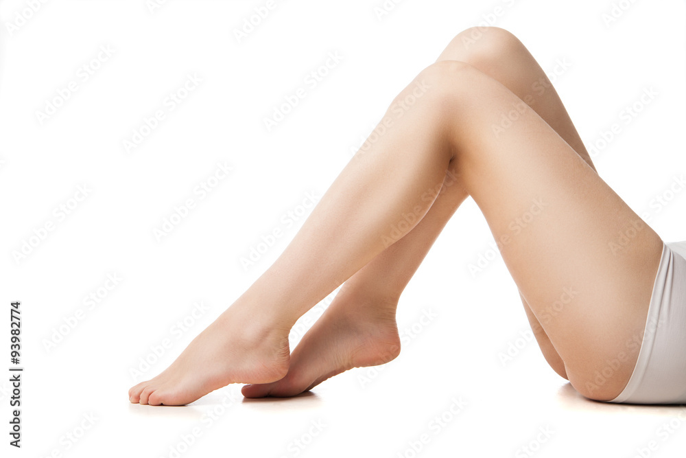 Close-up of young woman with beautiful legs lying 