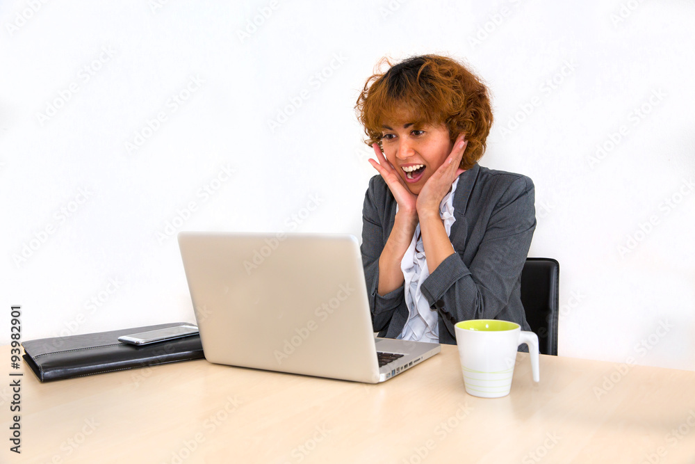 Women surprised over something showing at her computer Women surprised over something showing at her computer