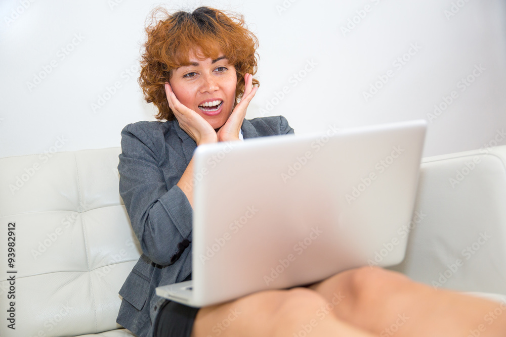 Women surprised over something showing at her computer