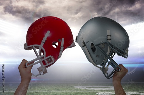 Composite image of american football player handing his helmet