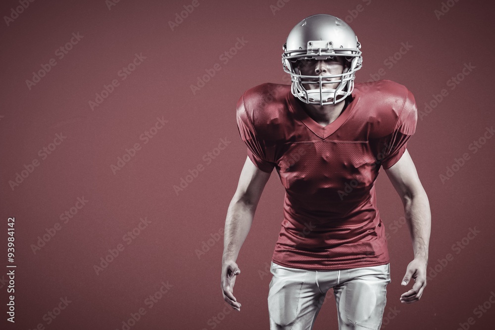 Composite image of american football player standing in position