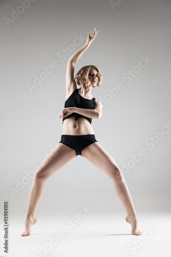 young beautiful woman in black T-shirt and shorts dancing