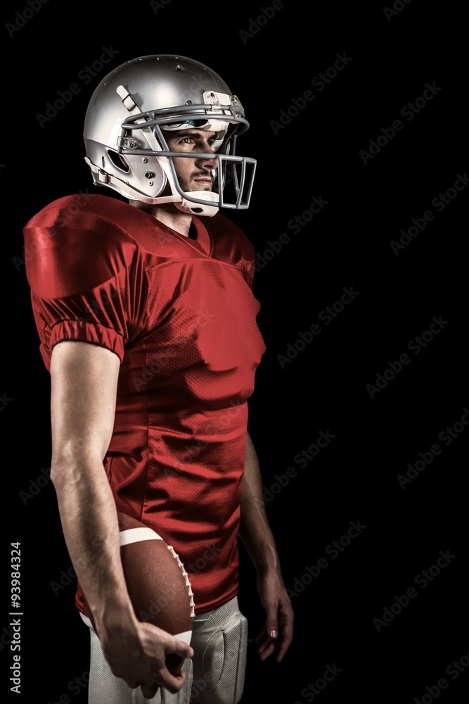 American football player standing with ball