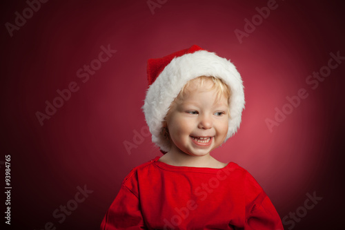 Happy baby in a Christmas cap