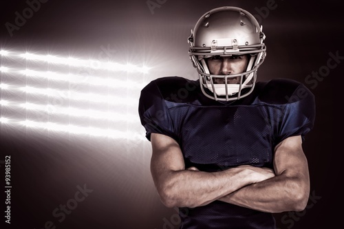 Composite image of american football player with arms crossed © vectorfusionart