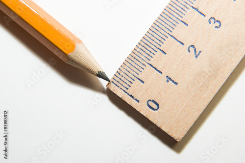 Pencil and wooden ruler on over white © zheltobriukh
