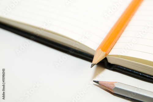 Notepads and pencils on a white background